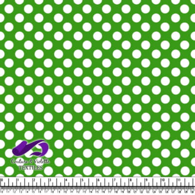 Green fabric with evenly spaced white polka dots